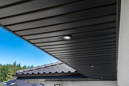A modern graphite roof lining is attached to the trusses, visible turned on LED lights.