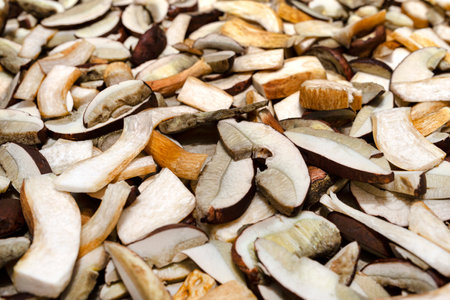 Background of sliced and raw edible mushrooms, lying on baking paper.の写真素材