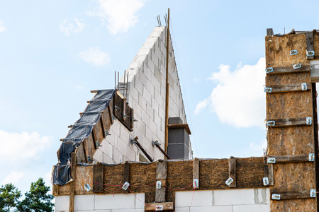 Wooden formwork made of shuttering boards of the gable wall rim and lintels.