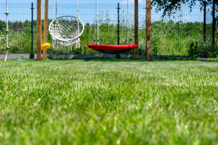 A modern cubic playground made of wooden logs and metal corners, a visible rocker and a nest.の写真素材