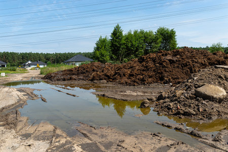 Digging out peat from marshy swamps, visible mountains made of peat.の写真素材