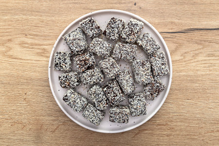 Australian Leamington dessert covered with coconut flakes lying on a plate.の写真素材
