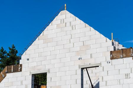 Wooden formwork made of gable wall formwork boards, white bricks visible.の写真素材