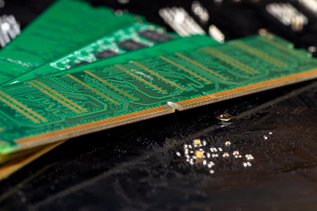 A stack of old SDRAM memory modules lying on a printed circuit board.の写真素材