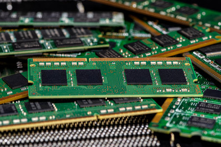 A stack of old SDRAM memory modules lying on a printed circuit board.