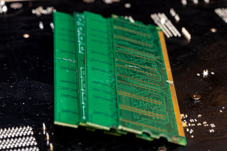 A stack of old SDRAM memory modules lying on a printed circuit board.の写真素材