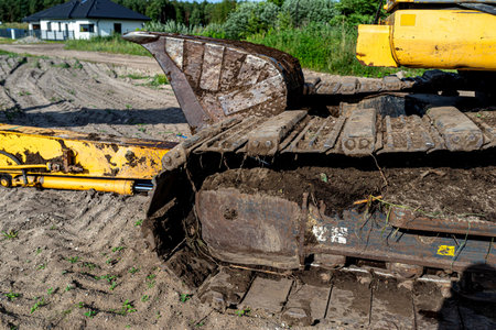 Heavy construction machinery excavator with tracks and hydraulic arm preparing terrain