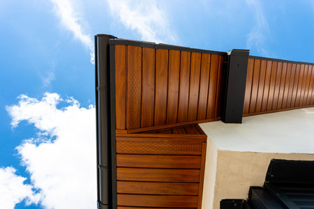 House displaying detailed softness, flashing, and gutter system against blue sky