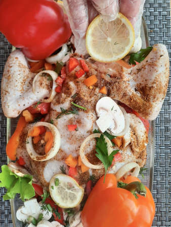 Grilled chicken fillet with vegetables and spices in a frying panの写真素材