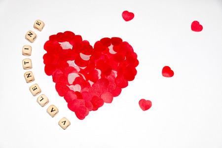 white cubes with black letters beside a bigger red heart made of smaller red hearts on a white backgroundの写真素材