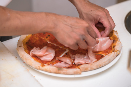 chef making pizza at kitchenの写真素材