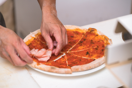 chef making pizza at kitchenの写真素材