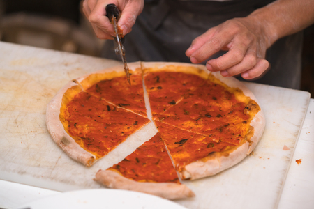 chef cutting pizzaの写真素材