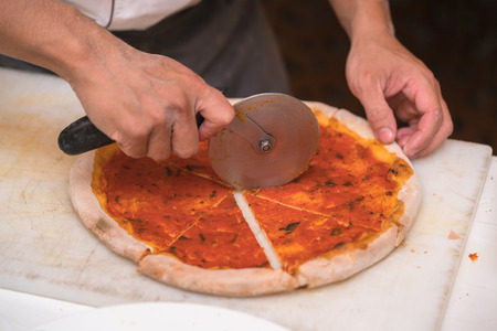 chef cutting pizzaの写真素材