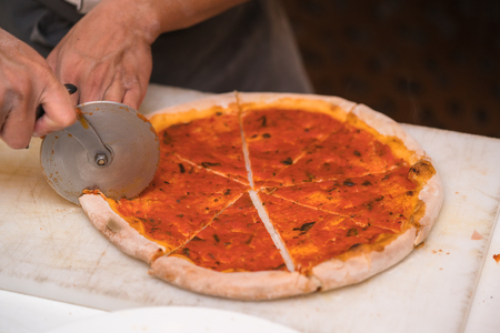 chef cutting pizzaの写真素材