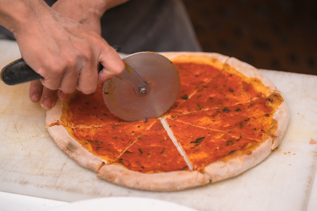 chef cutting pizzaの写真素材