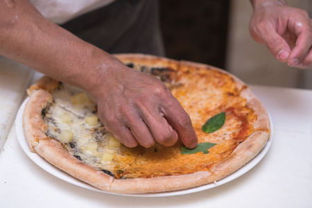 chef making pizza at kitchenの写真素材