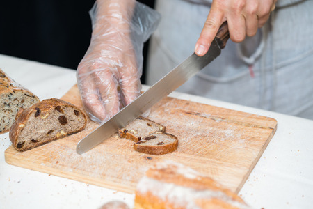 chef slicing bread in th kitchenの写真素材