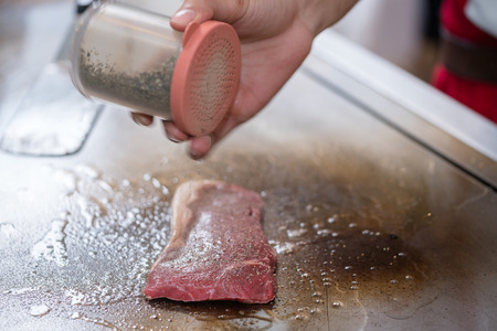 cooking beef steak on panの写真素材