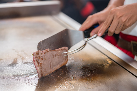 cooking beef steak on panの写真素材