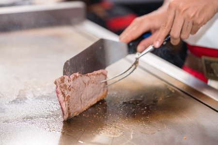 cooking beef steak on panの写真素材