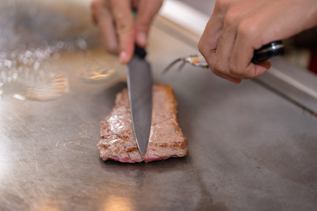 cooking beef steak on panの写真素材