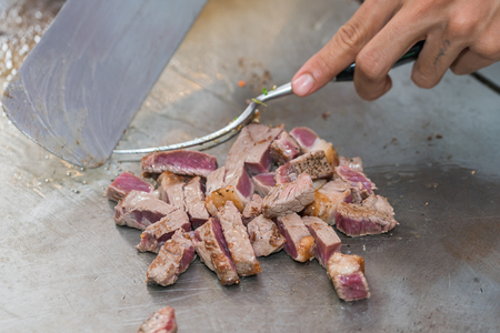 cooking beef steak on panの写真素材