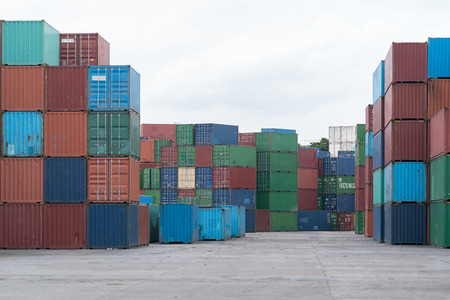 Crane lifting up container in yardの写真素材