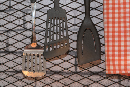Set of kitchen utensils hanging on the wall