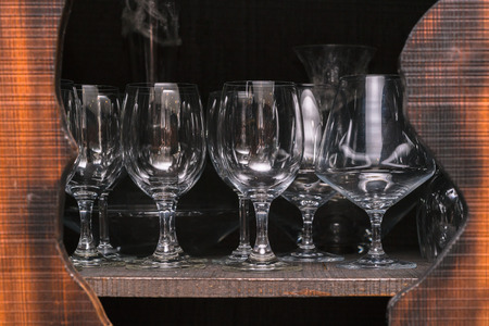 Crystal wine glasses arranged in a cupboardの写真素材