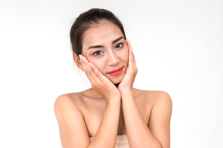 Beautiful woman cares for the skin face - posing at studio isolated on white with clipping path,asian Beauty.の写真素材