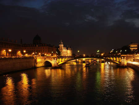 seine river at night with boat movingの写真素材