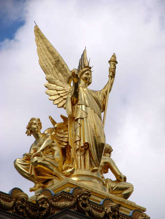 statue of some angels on the rooftop of the opera building in Parisの写真素材