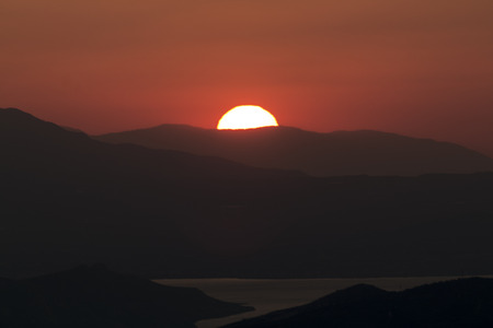 Sunset over mountainの写真素材
