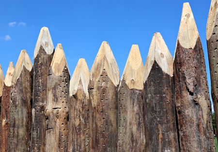 A fence made of sharpened pointed logsの写真素材