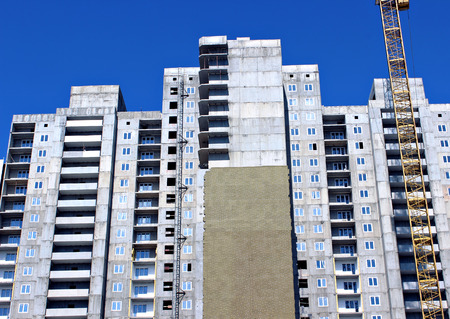 Installation of thermal insulation plates of mineral wool of a facade of monolithic reinforced...