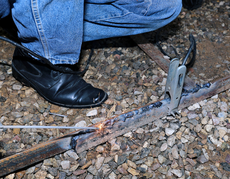 The worker spends electric welding work at the construction site