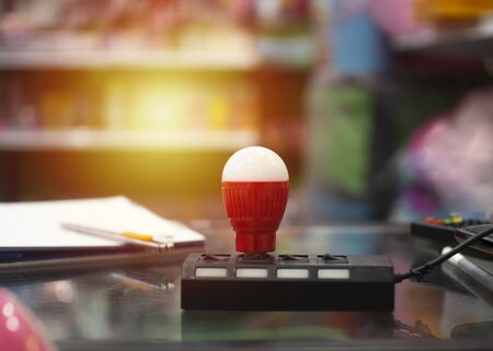 The lamp is turned on a light orange burst. Sometimes a symbol of the idea.