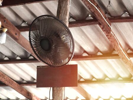 Fans of old wooden wall in the restaurant to make the air cooler.の写真素材
