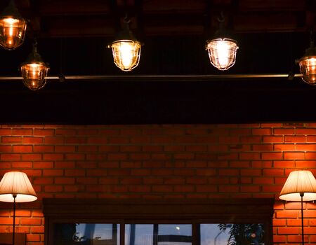 Lamp by the window glass A brown brick wallの写真素材