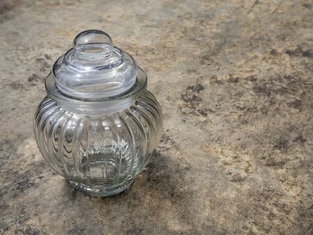 Empty glass jars on the cement floor for food or for the orderly and beautiful.の写真素材