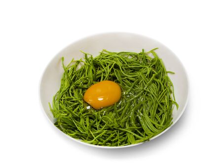 Omelet with Climbing Wattle on a white background,with clipping path,Fried egg on vegetables Wait until the mixture is mixed and then fried in a hot pan that is ready for fryingの写真素材