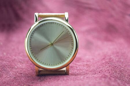Watch gold on a red background.