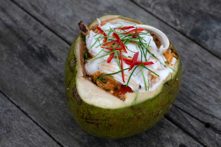 Steamed curry fish, shrimps and squid in coconutの写真素材