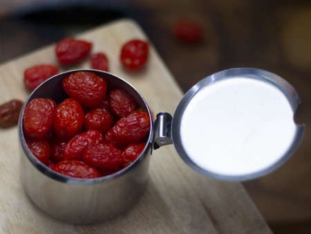 Dried Cherry Tomatoes in a Silver Box On a dark wood backgroundの写真素材