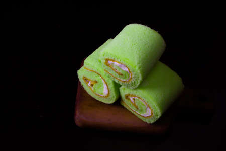 Pandan roll cake on dark background
