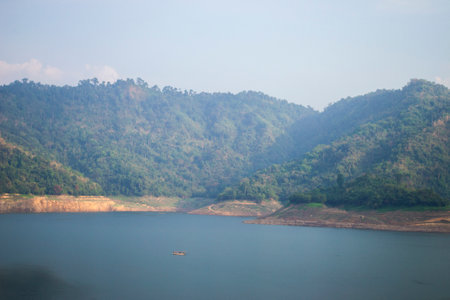 Private passenger ship In the green lake Behind a blurred green mountainの写真素材