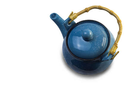 Blue ceramic teapot, looking from above, having a tea set makes us want to drink more tea, possibly from making tea by ourselves, on a white backgroundの写真素材