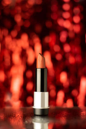 Red lipstick on a wet mirror with red bokeh background, beautiful and elegant, suitable for ladiesの写真素材