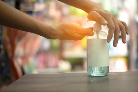 hand washing with alcohol gel It has become common in public places or shopping malls to prevent infectionの写真素材